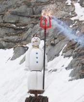 يقف «بويوج»، وهو رجل ثلج مصنوع من الحشو ومليء بالمفرقعات النارية، على موقد نار عند جسر بالقرب من منتجع جبال الألب في سويسرا.    «رويترز»