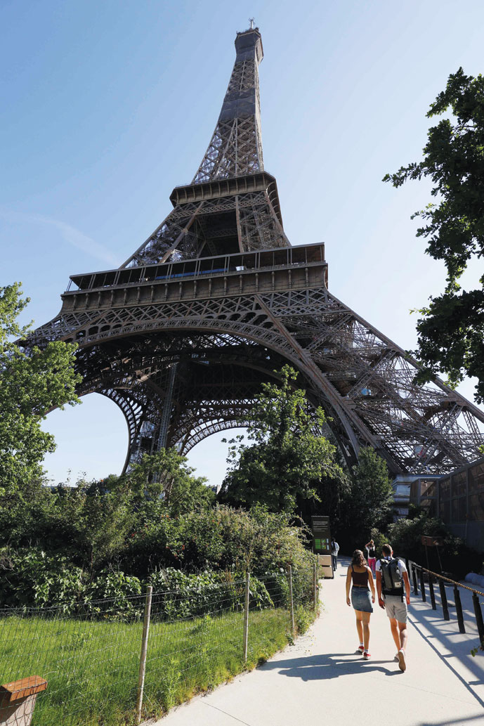 زوار يصلون إلى برج إيفل مع إعادة الفتح الجزئي للبرج في باريس، بعد إغلاق دام ثلاثة أشهر بسبب فيروس كورونا.ا ف ب